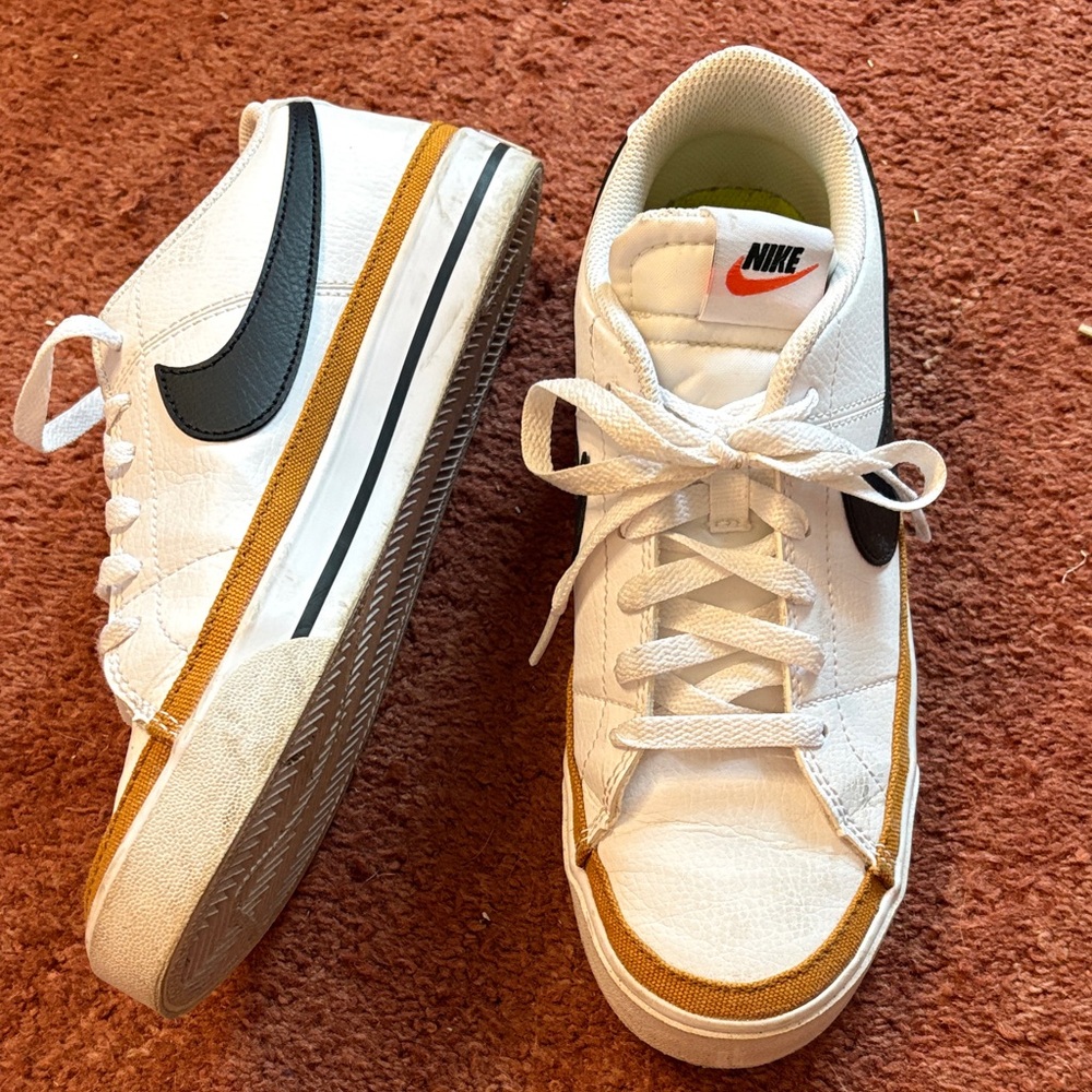Nike White Sneakers with Black and Gold Accents